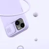 A close-up of a purple phone case with a sliding camera cover, set against a light purple background with floating spheres. Produktbild-Vorschau