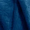 A close-up view of a quilted blue blanket. Produktbild-Vorschau