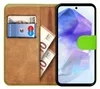 A book-style phone case with a phone inserted, showing cards and cash inside. Produktbild-Vorschau