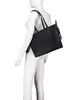 A black tote bag is displayed on a white mannequin. Produktbild-Vorschau