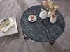 A round marble-look coffee table with a teapot, teacup, and flowers. Produktbild-Vorschau