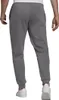 A person wearing grey Adidas jogging pants. Náhľad obrázku produktu