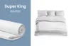 A split image showing a rolled-up mattress topper on the left and a made bed with white bedding on the right. Produktbild-Vorschau