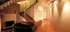 A modern interior with a staircase, sofa, and fireplace. Náhľad obrázku produktu