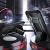 Two black phone cases with kickstands are displayed on a futuristic, abstract platform with red accents. Produktbild-Vorschau
