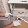 A person wearing white gloves is installing drawer slides on a white cabinet. Produktbild-Vorschau