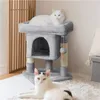 Two cats are on and around a grey cat tree in a room. Podgląd zdjęcia produktu