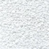 A close-up, overhead view of small, white, granular particles. Produktbild-Vorschau