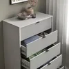 A close-up view of a gray dresser with several drawers open, revealing folded clothes inside. Decorative items are placed on top of the dresser. Podgląd zdjęcia produktu