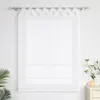 A white sheer Roman blind with a decorative top band hangs on a window against a white wall. A green plant is visible on the left, and a small decorative table with items is on the right. Produktbild-Vorschau