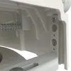 A close-up view of the internal components of a white plastic toilet seat riser. Produktbild-Vorschau