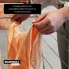 A person is hanging laundry on a drying rack. Produktbild-Vorschau