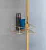 A gold corner shelf in a shower with shampoo bottles. Podgląd zdjęcia produktu