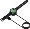 A black smartwatch with a green screen is connected to a charging cable and dock. Anteprima dell’immagine prodotto