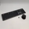 A wireless keyboard and mouse set with a USB receiver, laid out on a white and light gray surface. Produktbild-Vorschau