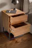 A wooden nightstand with two open drawers next to a bed. Anteprima dell’immagine prodotto