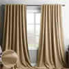 Two beige curtains hanging in front of a window. Anteprima dell’immagine prodotto