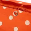 A close-up view of an orange polka dot shopper bag with a silver grommet and an orange zipper. Podgląd zdjęcia produktu