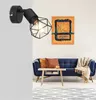 A modern living room with a blue sofa, coffee table, and a wall lamp. Náhľad obrázku produktu