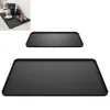 A collage showing two black silicone mats, one with a coffee machine and cups on it, and two separate views of the mats. Produktbild-Vorschau