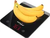 A digital kitchen scale with three bananas on top. Produktbild-Vorschau