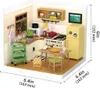 A miniature dollhouse kitchen scene with various accessories. Podgląd zdjęcia produktu