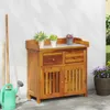 A wooden garden cabinet with plants and gardening tools. Produktbild-Vorschau
