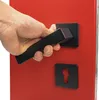 A hand is shown operating a black door handle on a red door. Produktbild-Vorschau