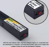 A close-up of a black capacitor discharge pen with labels and a red LED indicator light. Produktbild-Vorschau