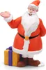 A figurine of Santa Claus standing next to a gift box. Produktbild-Vorschau