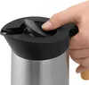 A hand is shown operating the lid of a thermal carafe. Voir les images du produit