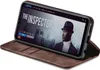 A smartphone in a brown flip case is displayed, showing a movie poster on its screen. Produktbild-Vorschau