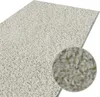 A close-up view of a cream-colored shaggy rug with a detailed inset showing the texture of the pile. Náhled obrázku produktu