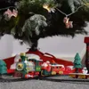 A toy train set with Santa Claus and a snowman is placed around the base of a Christmas tree. Náhľad obrázku produktu