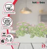 A white rectangular planter filled with lush green foliage and pink flowers, placed on a wooden table. The image features several circular icons with text labels on the left side, highlighting product features. Produktbild-Vorschau