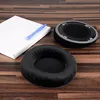 Replacement ear pads for headphones are laid out on a wooden surface next to a white box and a blue tool. Náhľad obrázku produktu