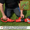 A person is kneeling on grass, assembling a red electric hedge trimmer. Produktbild-Vorschau