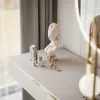 A vanity table with makeup and decorative items. Produktbild-Vorschau