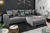 A modern living room with a large sectional sofa, coffee table, and decorative elements. Produktbild-Vorschau