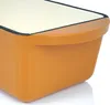 A close-up view of the corner of an orange cast iron baking dish with a cream interior. Náhľad obrázku produktu