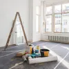 A room being renovated with painting supplies and a ladder. Produktbild-Vorschau