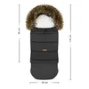 A black winter footmuff with a fur-lined hood, shown flat against a white background with dimensions indicated. Podgląd zdjęcia produktu