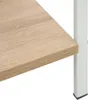 A close-up view of a wooden shelf and a white metal leg of a bookshelf. Náhled obrázku produktu
