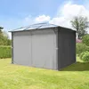 A garden gazebo with gray side panels and a clear polycarbonate roof, set up on a green lawn with trees and bushes in the background under a blue sky with clouds. Podgląd zdjęcia produktu