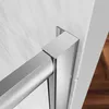A close-up view of a shower door hinge and frame, showing the metallic finish and the connection to the wall and floor. Produktbild-Vorschau