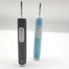 Two electric toothbrushes, one black and one blue, are displayed against a white background. Anteprima dell’immagine prodotto