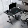 A gaming desk setup in a room with a window and shelving. Produktbild-Vorschau