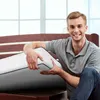 A man is placing a mattress on a bed frame. Produktbild-Vorschau