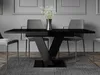 A modern dining table with a glossy black finish and a unique V-shaped base, set in a minimalist dining room with grey walls and chairs. Anteprima dell’immagine prodotto
