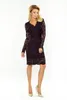 A woman modeling a black lace dress. Náhled obrázku produktu